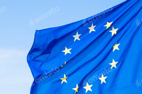 Preview: Close-up of the flag of the European Union with twelve yellow stars on a blue background waving in t
