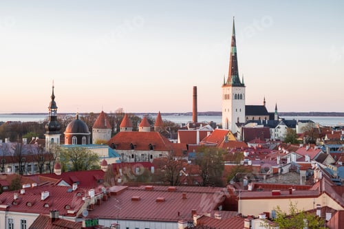 Preview: Breathtaking panoramic view of Tallinn Old Town at sunset with medieval fortress towers, red roofs,