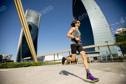 Preview: Running man in the city center with modern buildings in clear weather