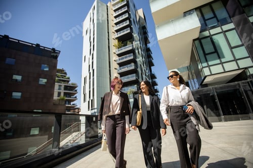 Preview: Business professionals enjoy a sunny stroll through a modern urban landscape