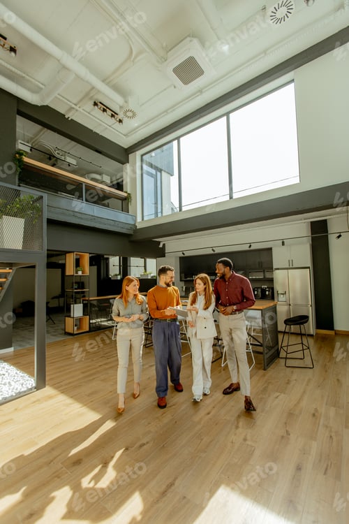 Preview: Group of four professionals discuss ideas in a modern office space during the day