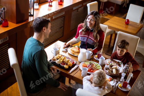 Preview: Family enjoys breakfast together at a cozy restaurant during the morning