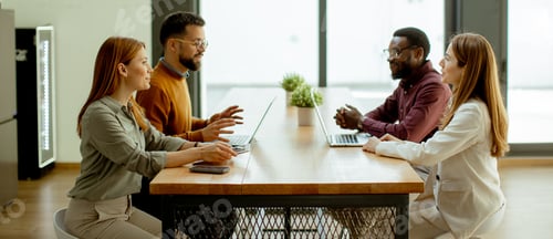 Preview: Collaborative discussion among four professionals in a modern office space
