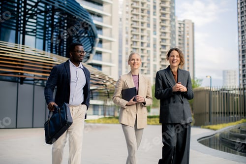 Preview: Professionals walking together in a city business district during the day