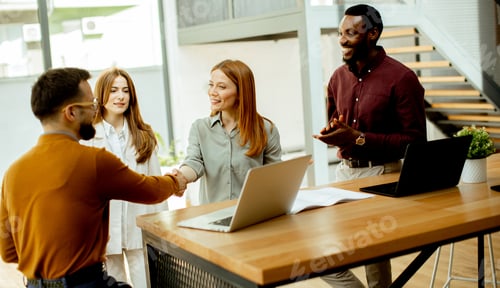 Preview: Business meeting with handshake and discussion in a modern office space