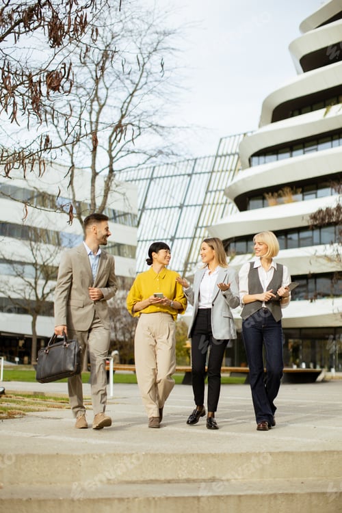Preview: Business professionals walking together in a modern city setting during daylight