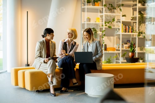 Preview: Three businesswomen collaborating in a modern workspace during the day