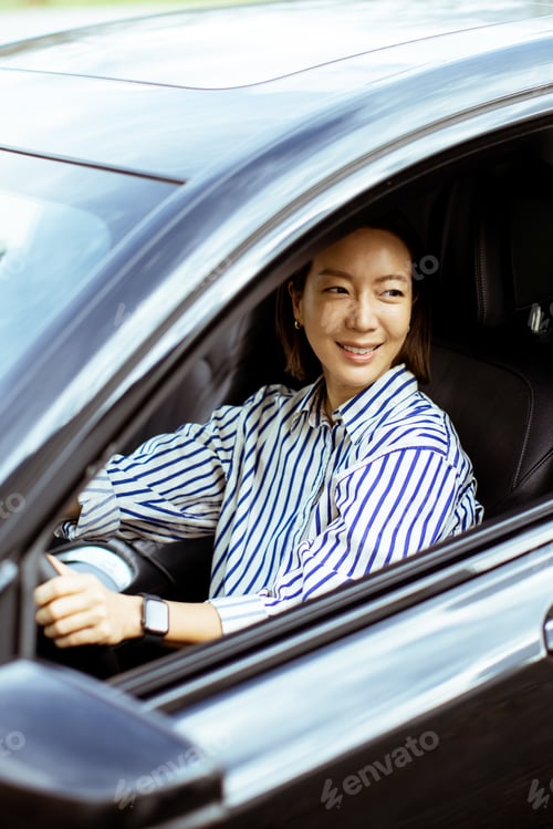 Preview: Korean woman driving a car on a sunny day in a city setting
