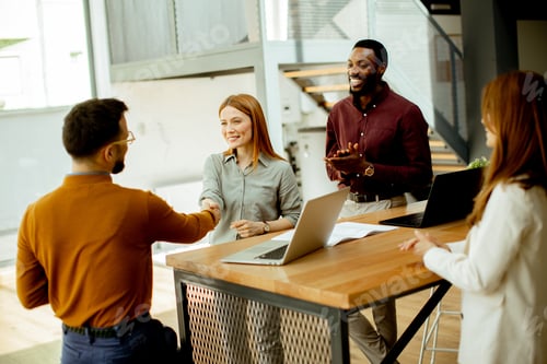 Preview: Business meeting takes place in a modern office with people discussing teamwork