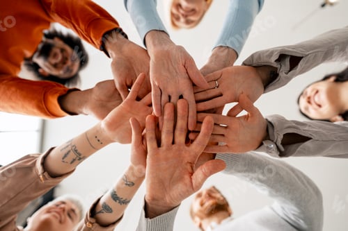Preview: Diverse group of people stacking hands in unity