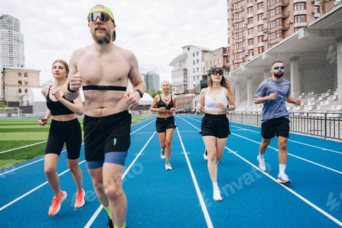 Preview: Group of athletes running on blue stadium track