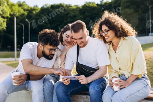 Preview: Friends enjoying content together on a smartphone outdoors