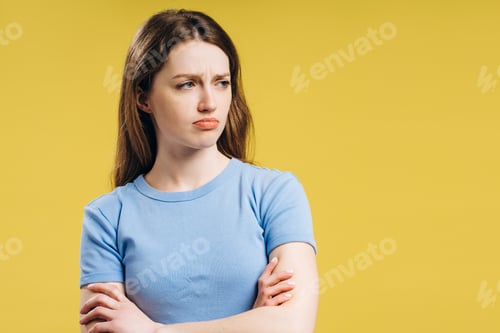 Preview: Young woman showing annoyance and disapproval with crossed arms