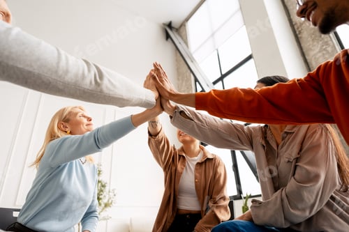 Preview: Diverse people joining hands in high five stack