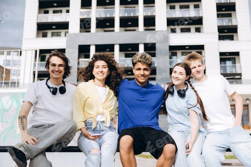 Preview: Diverse teenagers smiling on urban street enjoying friendship