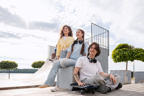 Preview: Three teenagers relaxing with skateboard at urban skatepark