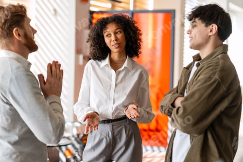 Preview: Diverse business people collaborating during an informal office meeting