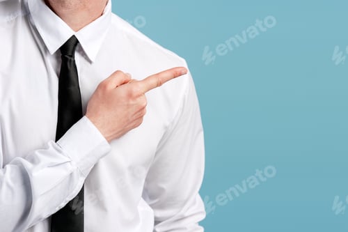 Preview: Businessman pointing arm and finger indicating direction