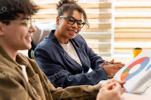 Preview: Business colleagues analyzing pie chart data during meeting