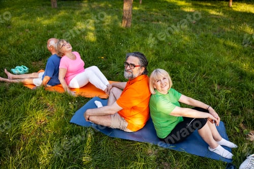 Preview: Seniors doing group exercise outdoors improving wellness