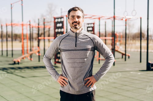 Preview: Confident athletic man standing in outdoor fitness park
