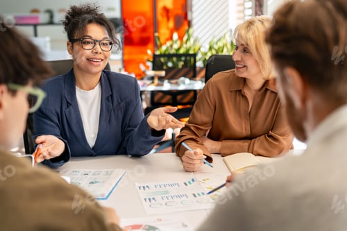 Preview: Diverse business team collaborating during an office meeting