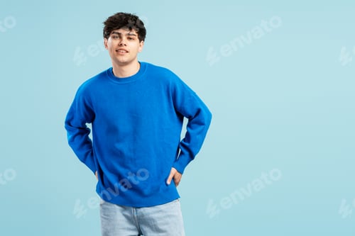 Preview: Youthful man posing confidently with hands in pockets