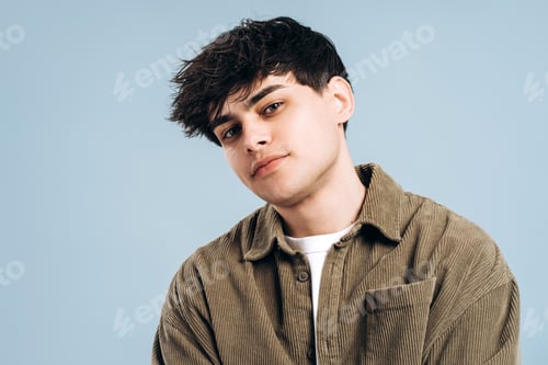 Preview: Close up portrait of young handsome man in corduroy shirt on soft blue background