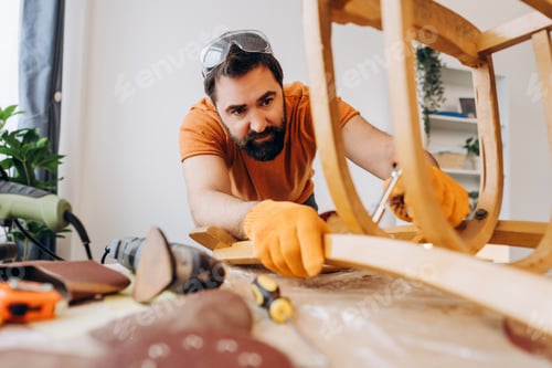 Preview: Man restoring vintage wooden chair in his home workshop