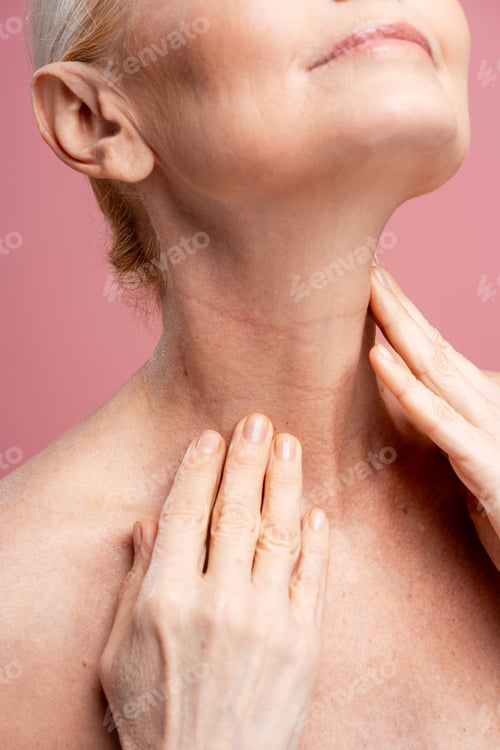 Preview: Senior woman aging skin checking neck for care