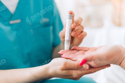 Preview: Healthcare professional testing blood sugar level using lancet