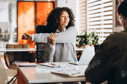 Preview: Portrait of tired African American woman working in modern office stretching