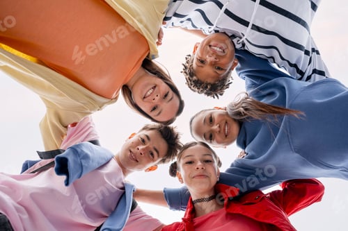 Preview: Diverse group of young friends smiling in a huddle