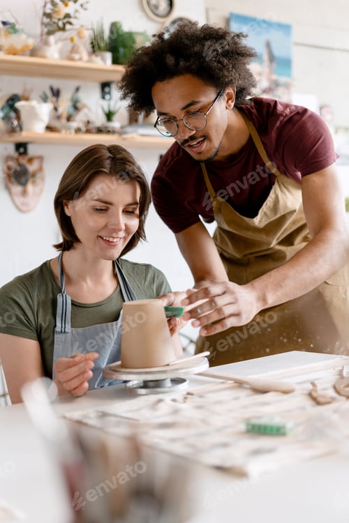 Preview: People learning pottery craftsmanship in art studio workshop