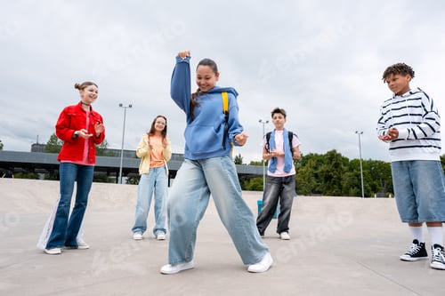 Preview: Diverse teenagers dancing and having fun in skate park