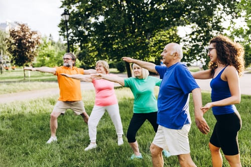 Preview: Seniors doing outdoor yoga class with young instructor