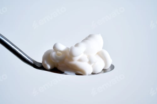Preview: White cosmetic innovation cream on spoon