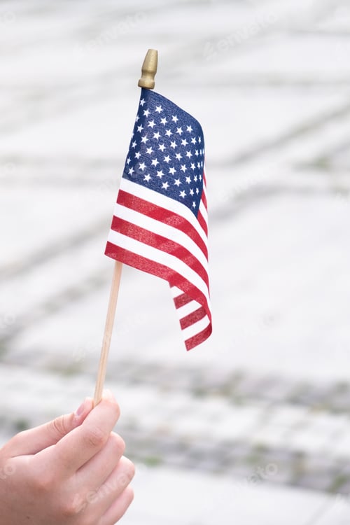 Preview: American flag in boy's hand outdoors. 4th july USA independence day concept