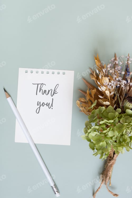 Preview: Sheet paper with text Thank you on colored background top view. Flat lay
