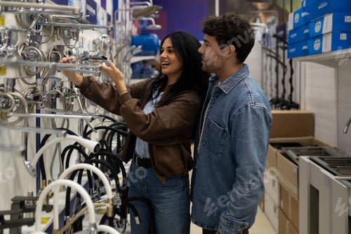 Preview: Couple selecting bath and kitchen fixtures for home renovation in store