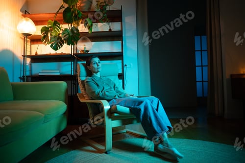 Preview: Disappointed upset senior woman with teary eyes sitting in chair showing apathy and loneliness.