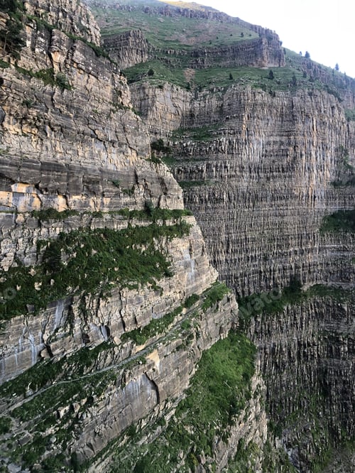 Preview: Towering layered rock cliffs creating natural wilderness landscape