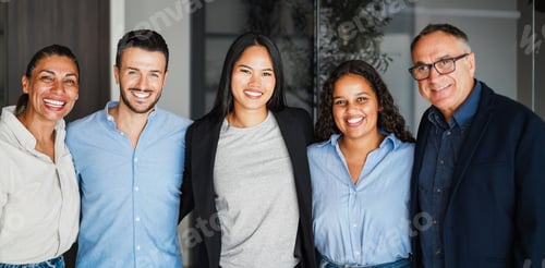 Preview: Multi generational workers smiling in front of camera inside business office