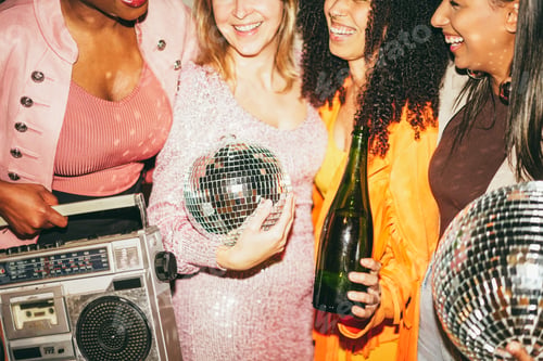 Preview: Group of multiracial girls dancing, drinking champagne and listening music outdoor