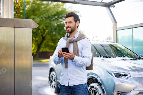 Preview: Man Using Phone at Car Wash