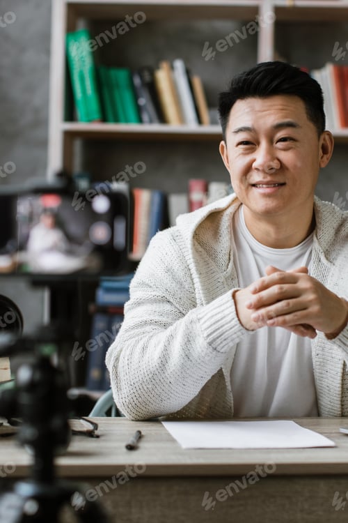 Preview: Man Filming Content at Desk