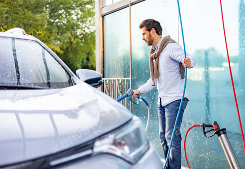 Preview: Man Washing Car at Self-Service Station