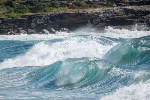 Preview: Powerful surf break with large breaking waves under overcast sky