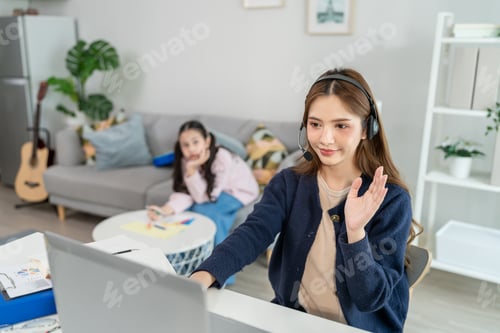 Preview: Young Woman Working From Home While Child Plays in Background