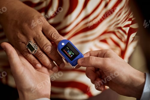 Preview: Middle Aged Woman Undergoing Pulse Oximeter Check in Clinic
